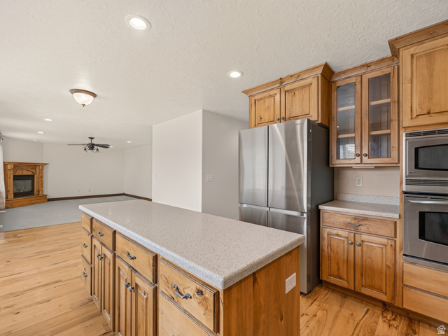 1279 West 1500th Street North Mapleton, UT 84664 - Photo 25 of 83 Kitchen featuring wood-finish flooring and cabinetry, light-toned countertops, and stainless steel appliances