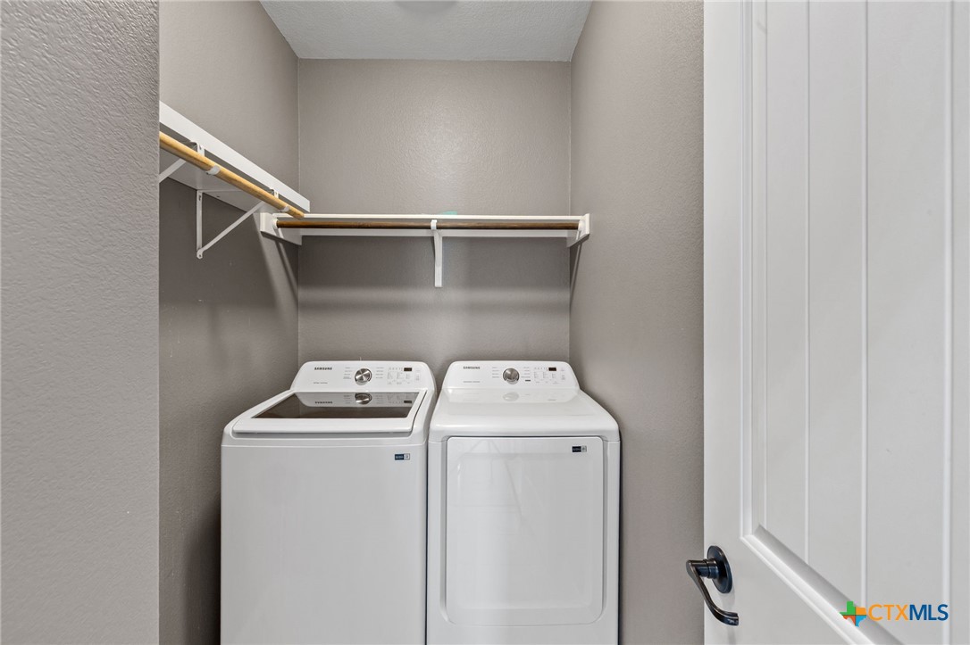 10113 Copper Ridge Cove Austin, TX 78747 - Photo 29 of 32 a utility room with dryer and washer