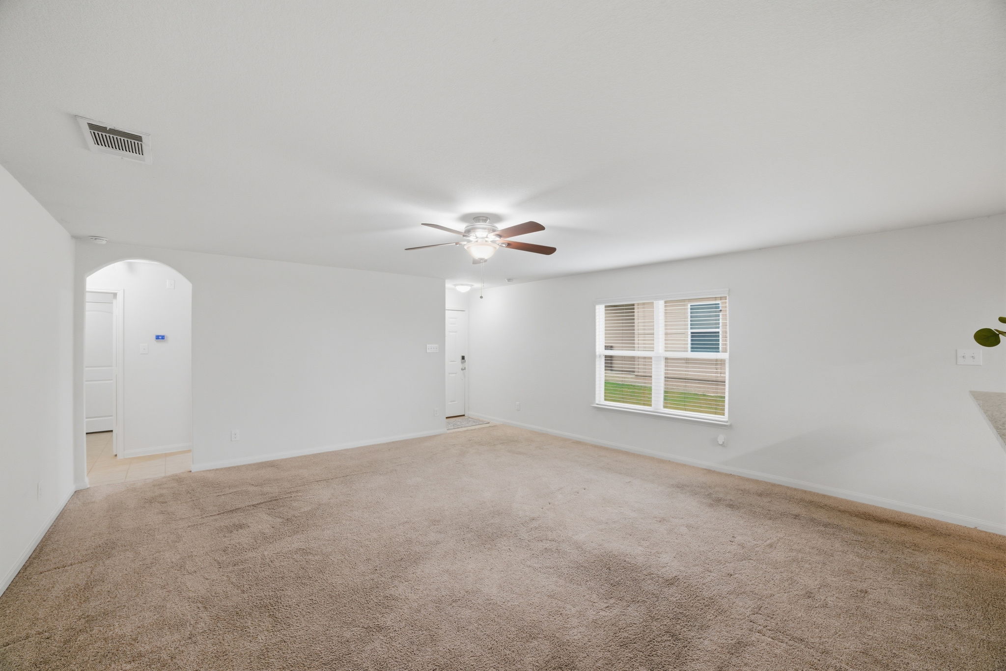 107 Millers Loop Jarrell, TX 76537 - Photo 14 of 31 an empty room with windows and ceiling fan
