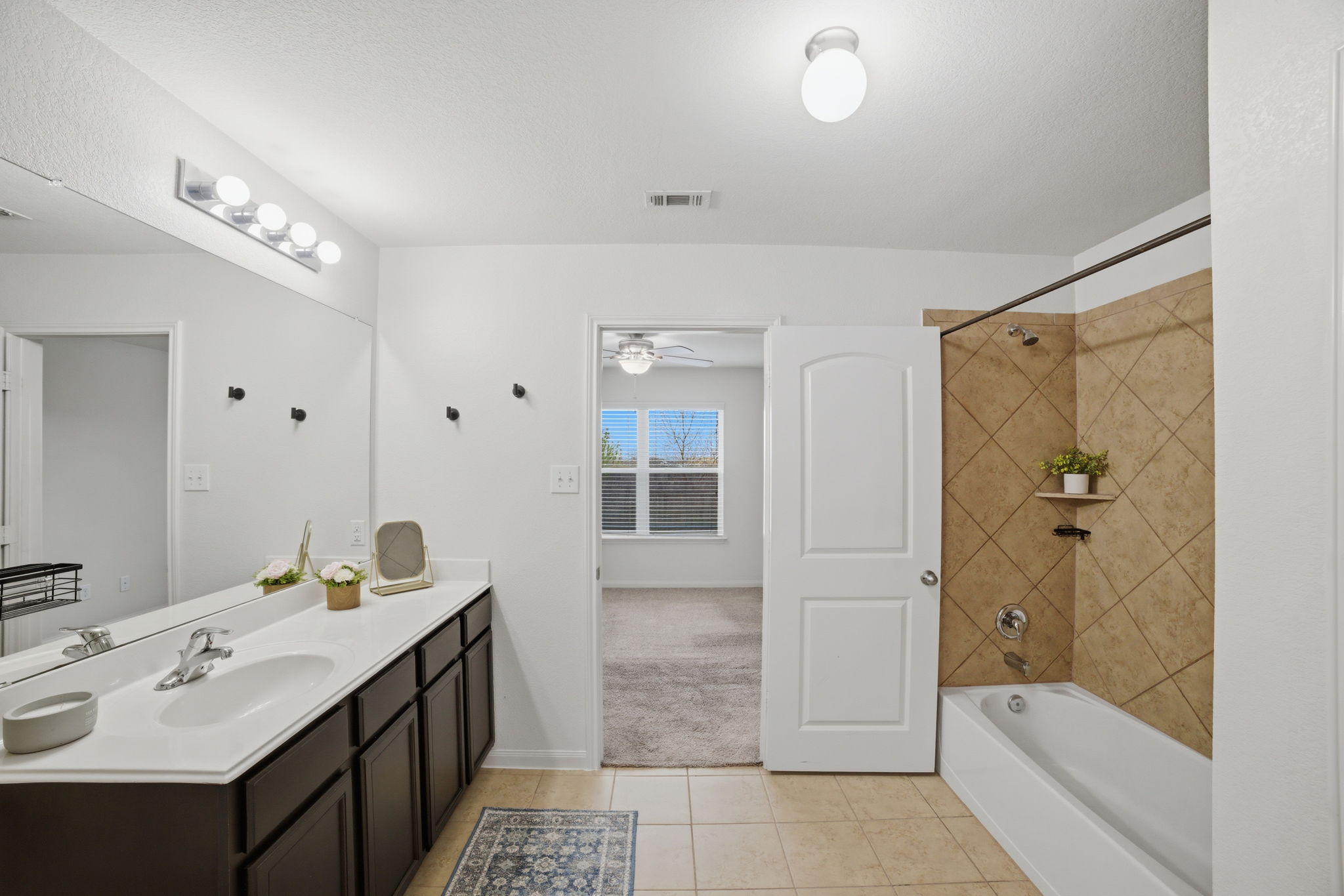 107 Millers Loop Jarrell, TX 76537 - Photo 18 of 31 a bathroom with a tub sink shower and mirror