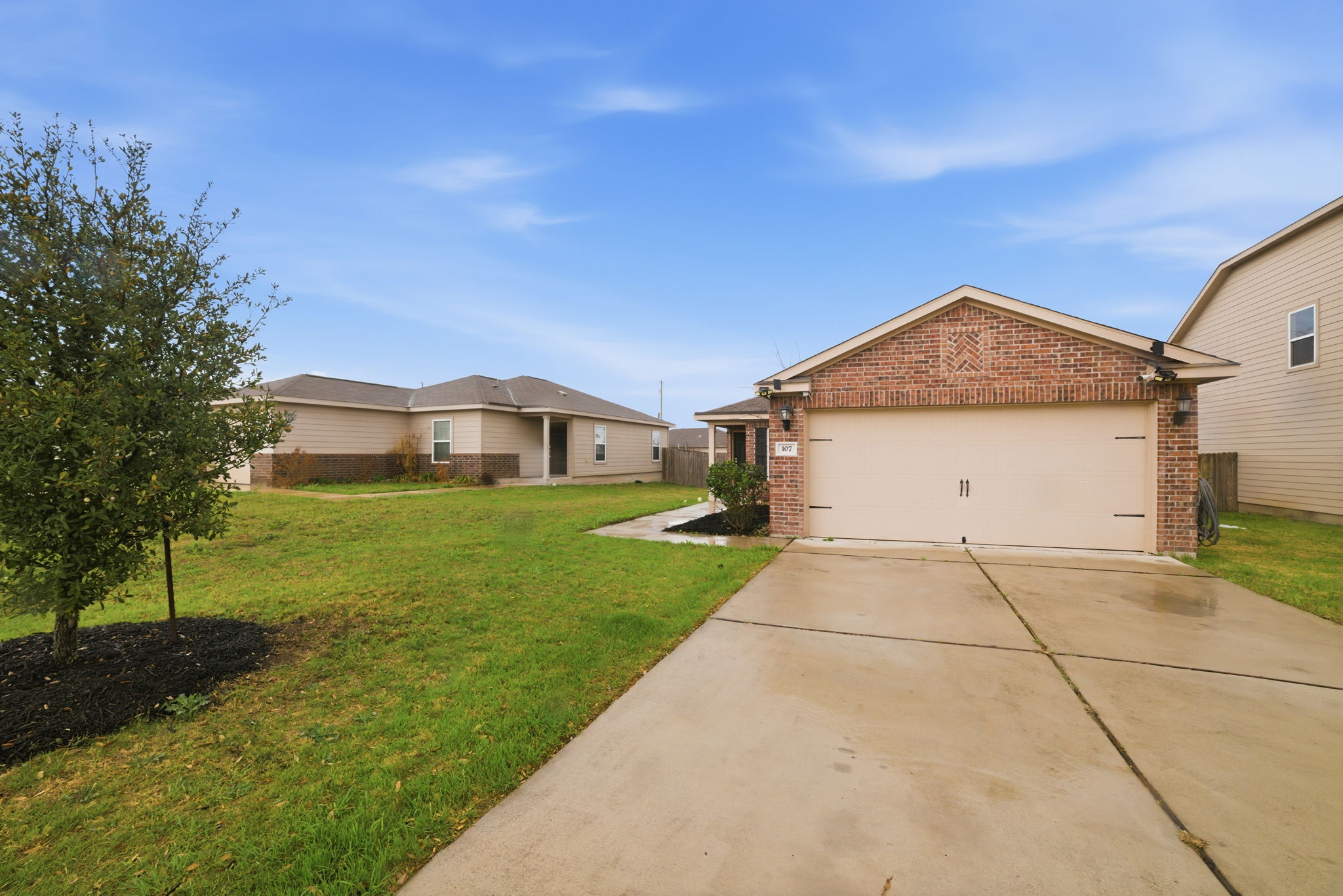 107 Millers Loop Jarrell, TX 76537 - Photo 30 of 31 a front view of a house with a yard and garage
