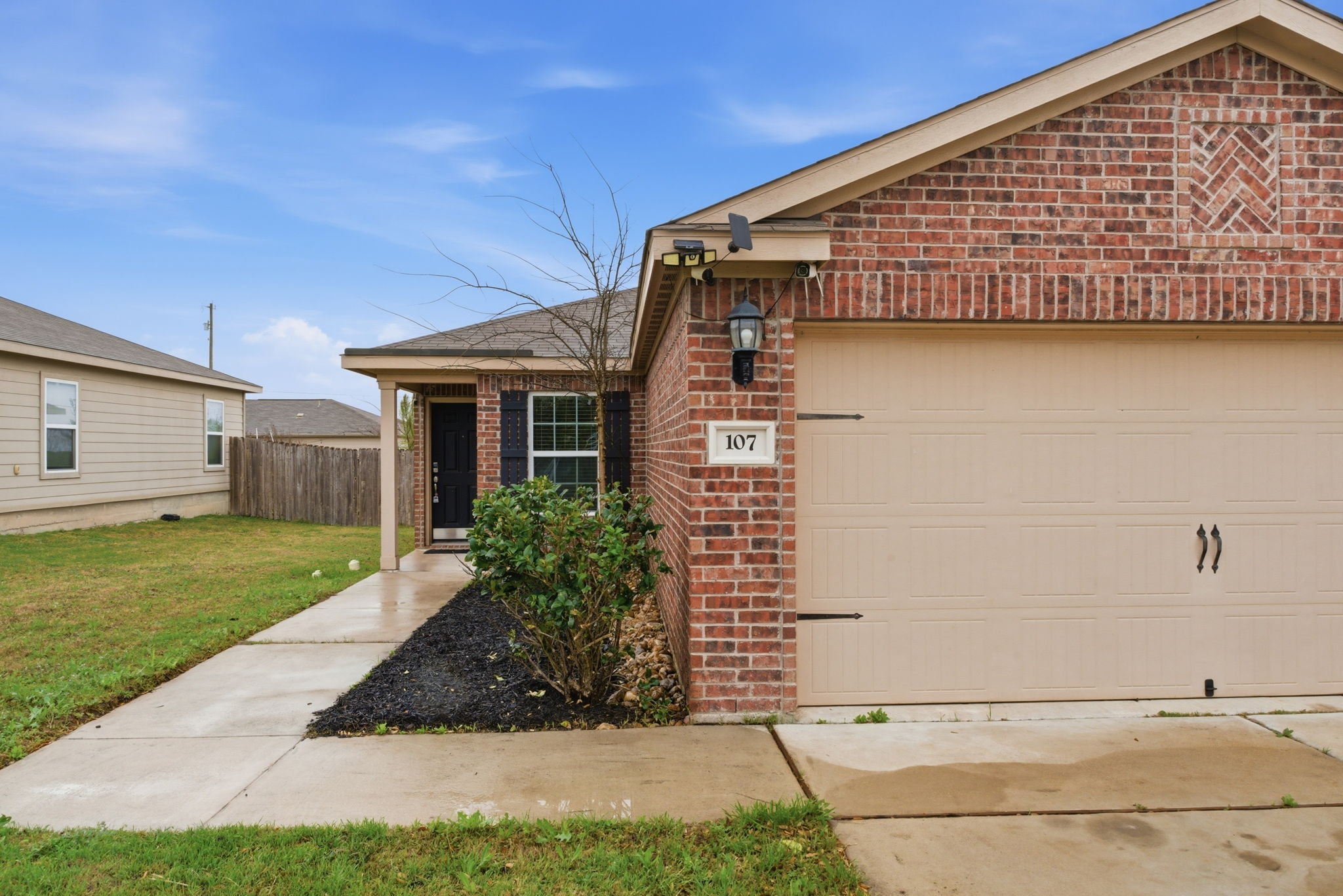107 Millers Loop Jarrell, TX 76537 - Photo 3 of 31 a front view of a house with garden