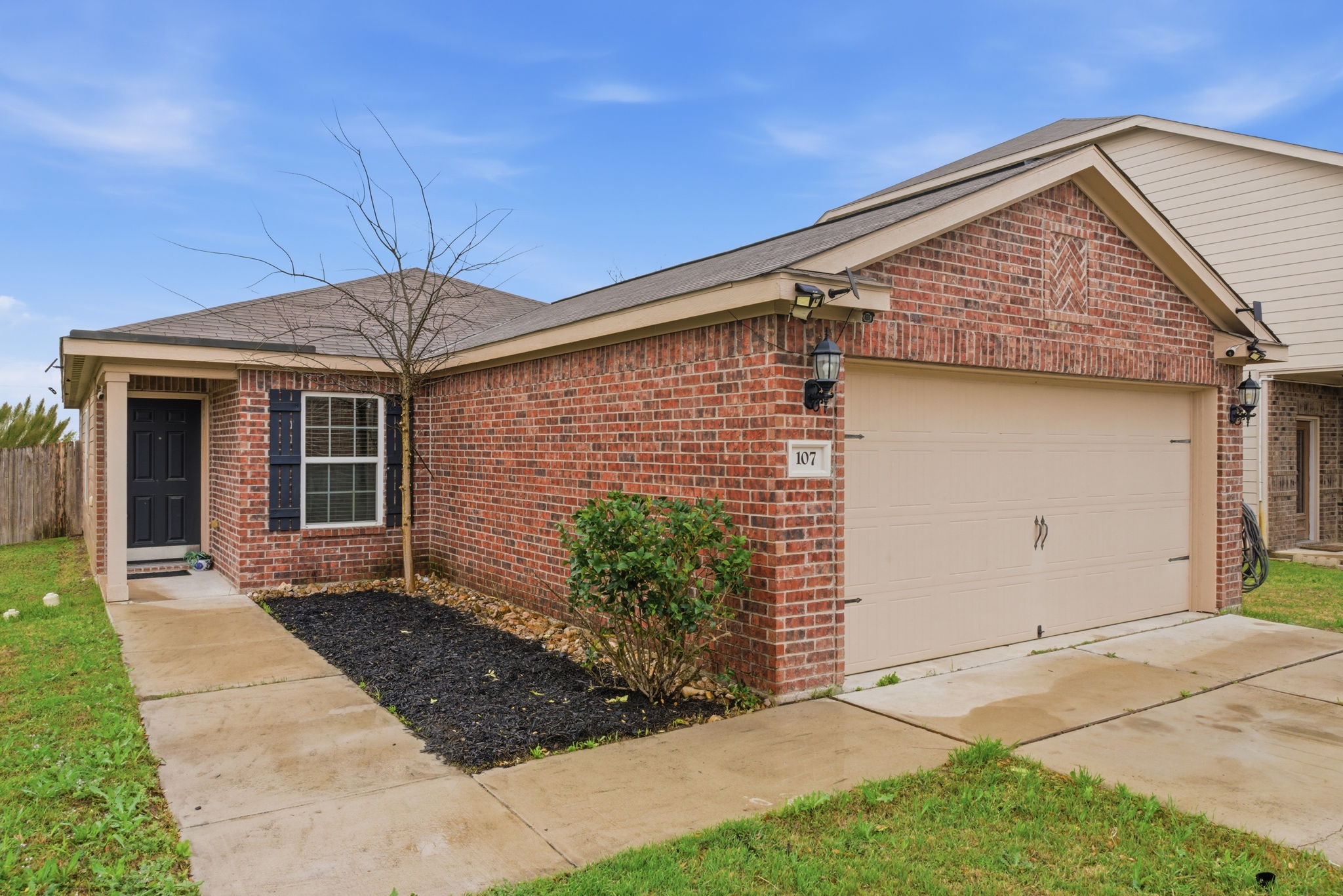 107 Millers Loop Jarrell, TX 76537 - Photo 4 of 31 a front view of a house with garden