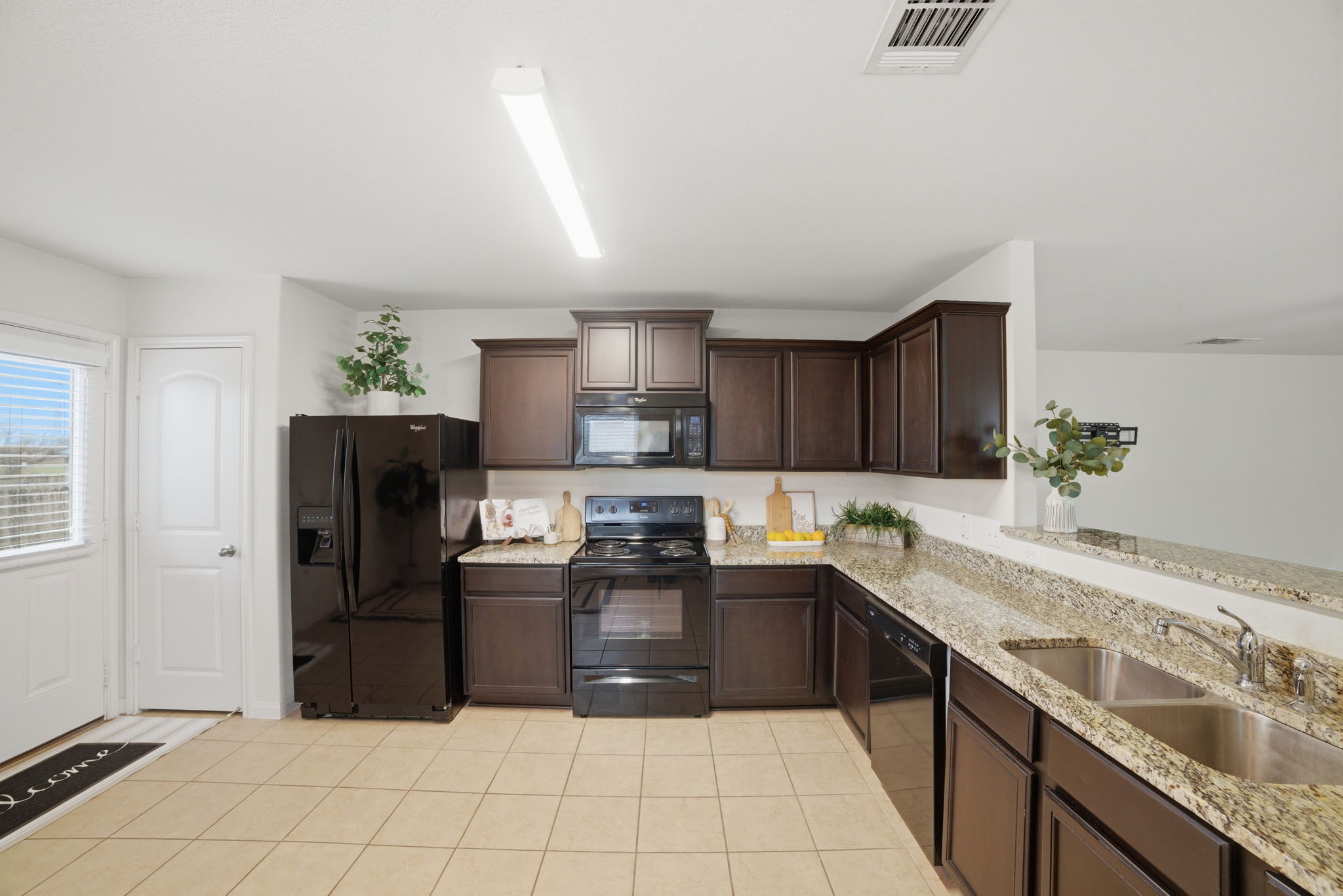 107 Millers Loop Jarrell, TX 76537 - Photo 5 of 31 a kitchen with granite countertop a refrigerator sink and cabinets