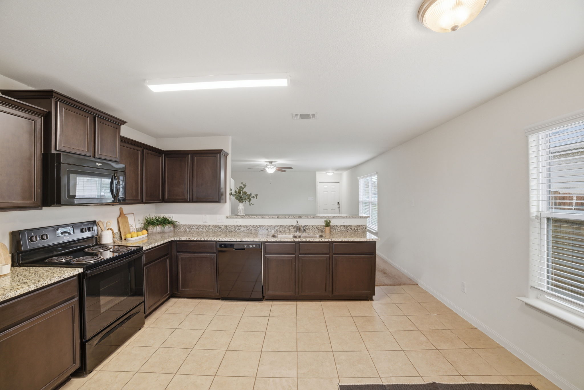 107 Millers Loop Jarrell, TX 76537 - Photo 6 of 31 a large kitchen with granite countertop a sink and cabinets