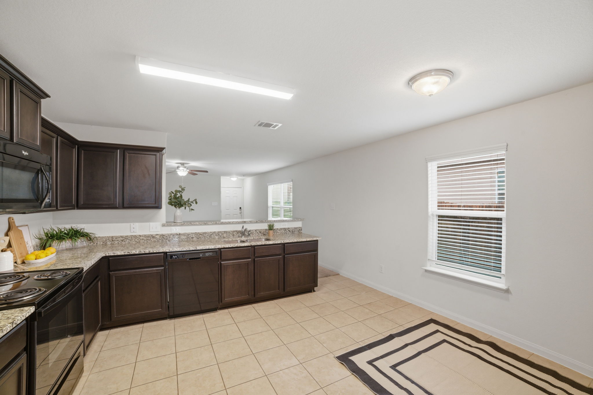 107 Millers Loop Jarrell, TX 76537 - Photo 8 of 31 a kitchen with stainless steel appliances a sink stove and cabinets