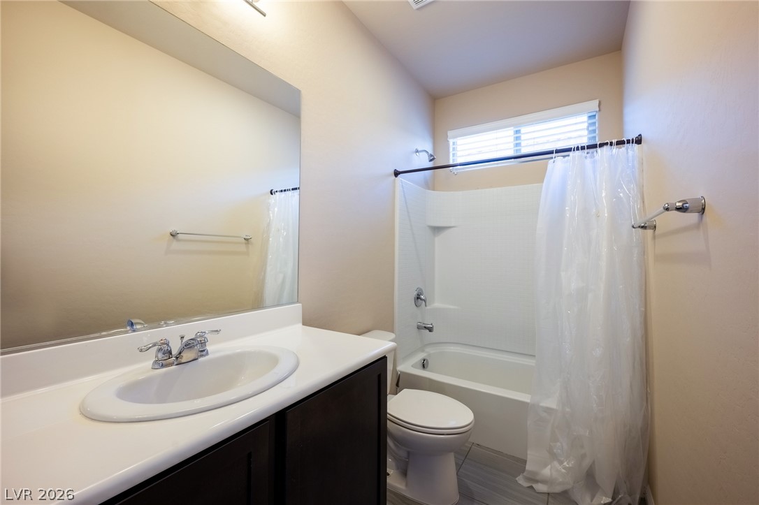 11016 Prairie Grove Road Las Vegas, NV 89179 - Photo 30 of 37 A well-appointed bath features a sleek vanity and a tub-shower combination.