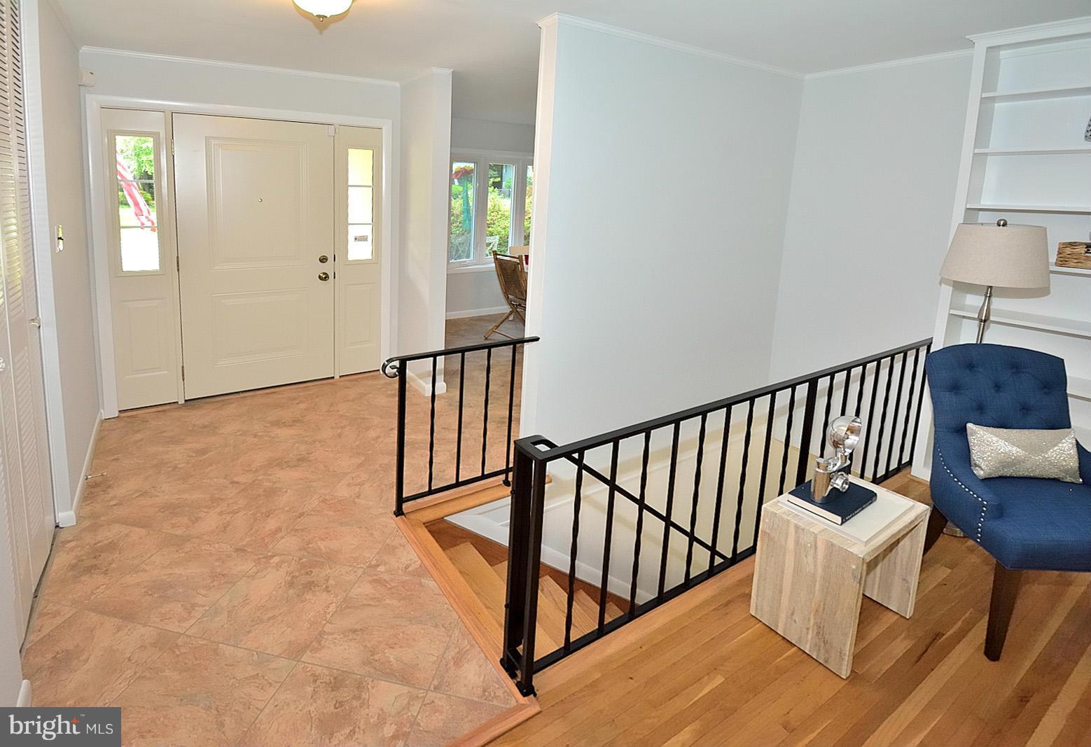 5613 Ravenel Lane Springfield, VA 22151 - Photo 3 of 30 a view of staircase with wooden floor and a rug