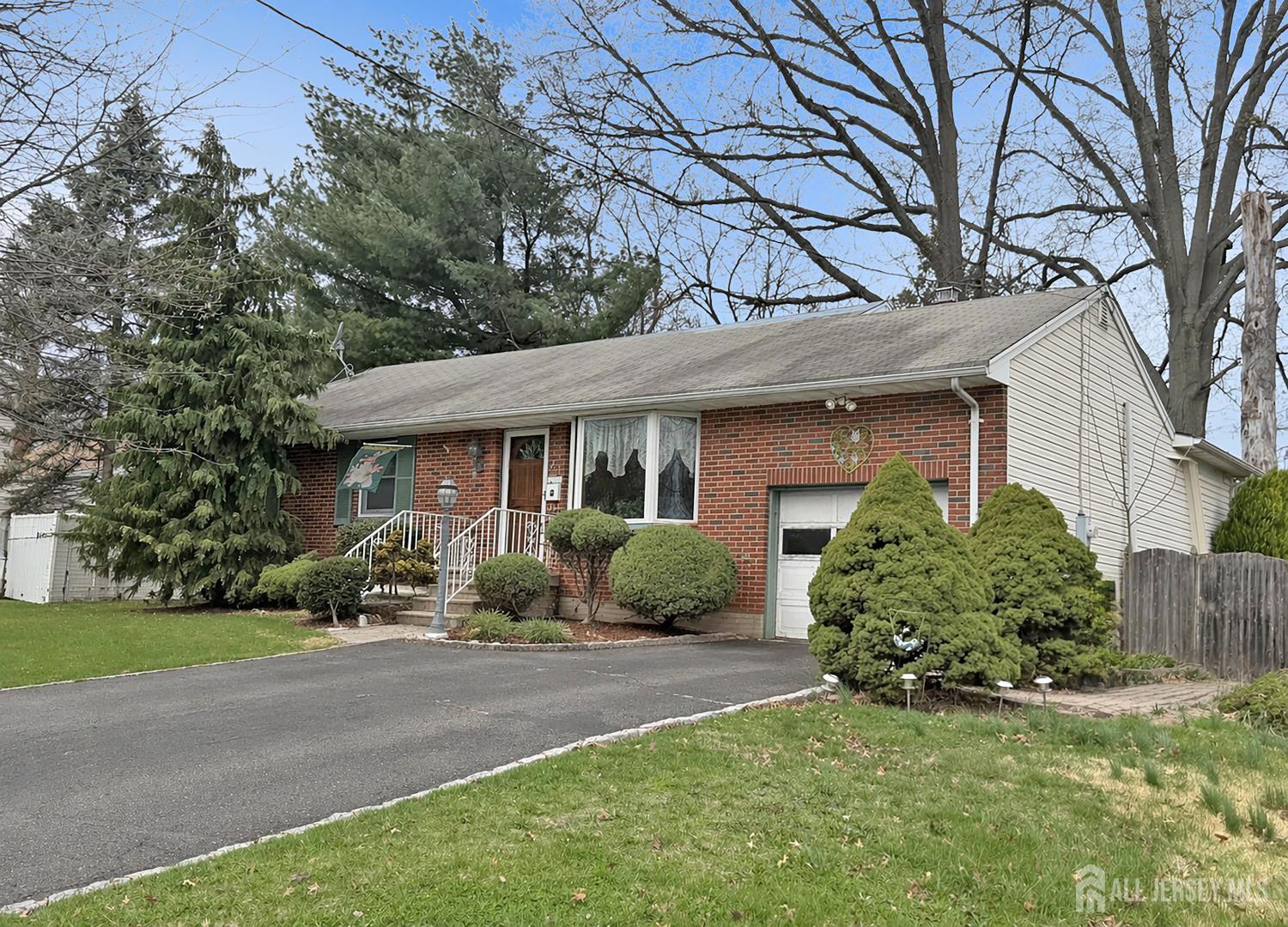 48 Morningside Road Colonia, NJ 07067 - Photo 3 of 4 a front view of a house with a yard and potted plants