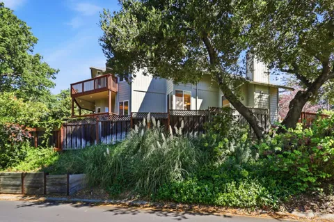a room with a table chairs and kitchen view