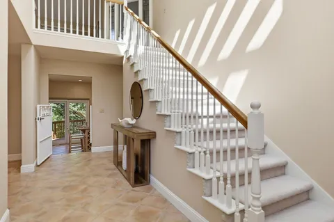 a spacious bedroom with a bed and a large window