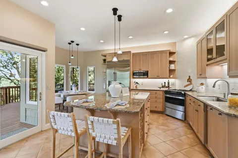 a view of a porch with furniture and garden