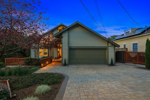 a living room with furniture fireplace and a potted plant