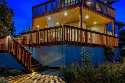 a view of a dining room with furniture wooden floor and a chandelier