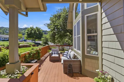 a kitchen with stainless steel appliances granite countertop a stove top oven a sink dishwasher a dining table and chairs with wooden floor