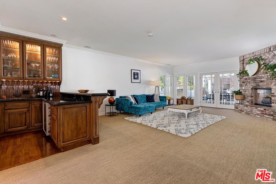 3827 Castle View Road Agoura Hills, CA 91301 - Photo 21 of 74 a living room with furniture a flat screen tv and a table