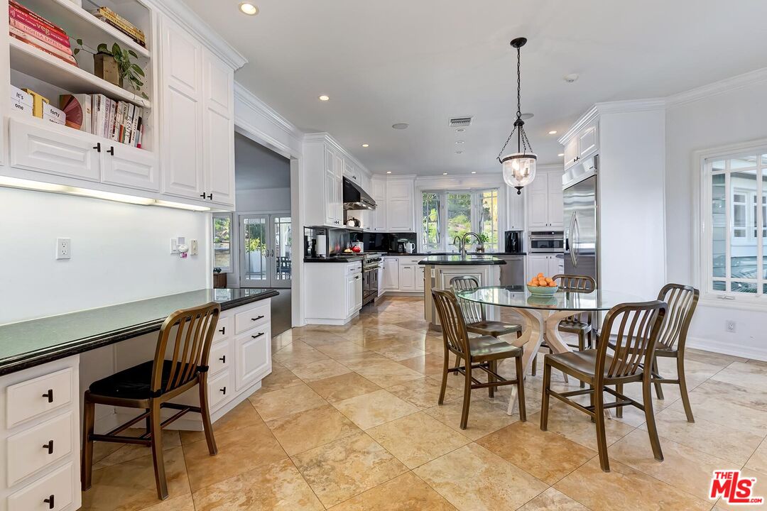 3827 Castle View Road Agoura Hills, CA 91301 - Photo 27 of 74 a view of a dining room and livingroom with furniture wooden floor a rug a rug a fireplace