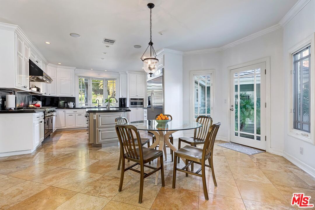 3827 Castle View Road Agoura Hills, CA 91301 - Photo 28 of 74 a view of a dining room and livingroom with furniture wooden floor a chandelier