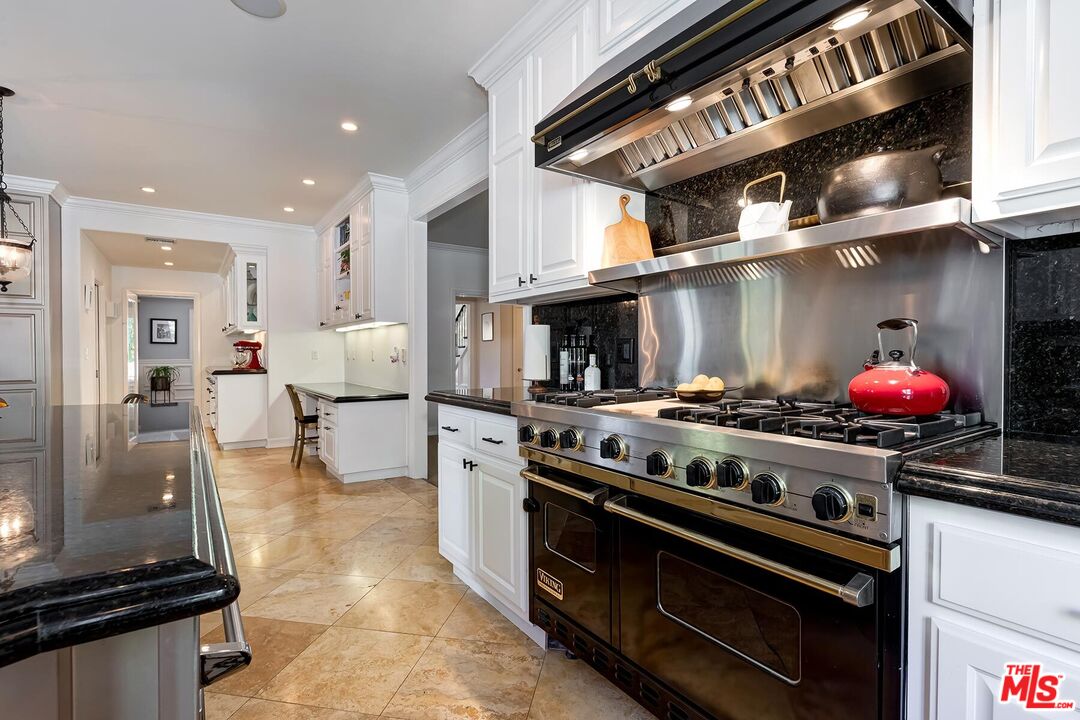 3827 Castle View Road Agoura Hills, CA 91301 - Photo 33 of 74 a kitchen with stainless steel appliances granite countertop a stove and a refrigerator