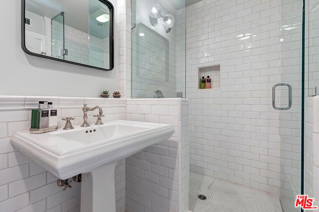 3827 Castle View Road Agoura Hills, CA 91301 - Photo 37 of 74 a bathroom with a sink a mirror a vanity and shower