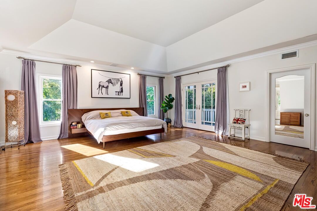 3827 Castle View Road Agoura Hills, CA 91301 - Photo 39 of 74 a bedroom with a large bed and a large window