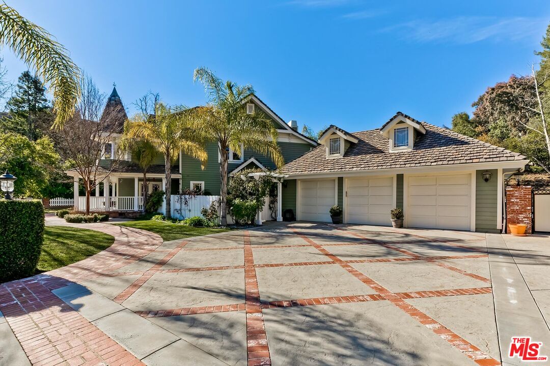 3827 Castle View Road Agoura Hills, CA 91301 - Photo 4 of 74 a front view of a house with a yard and potted plants