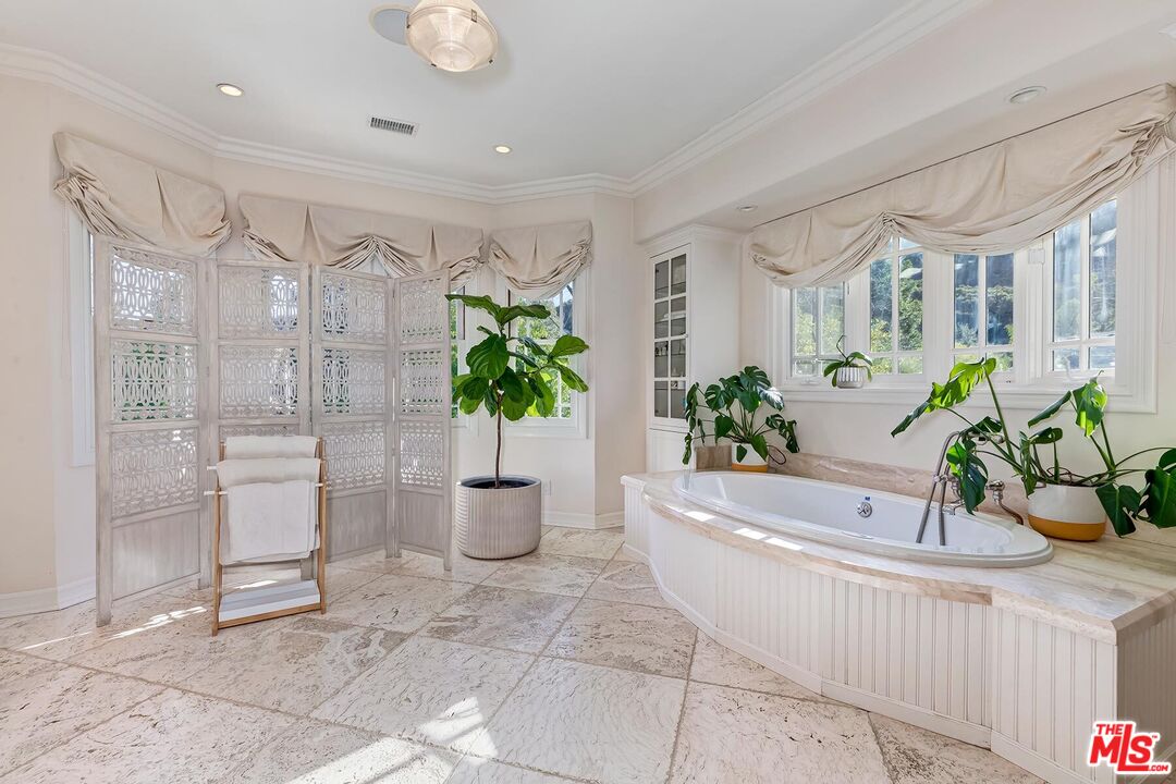 3827 Castle View Road Agoura Hills, CA 91301 - Photo 45 of 74 a white bath tub sitting in a bathroom next to a window