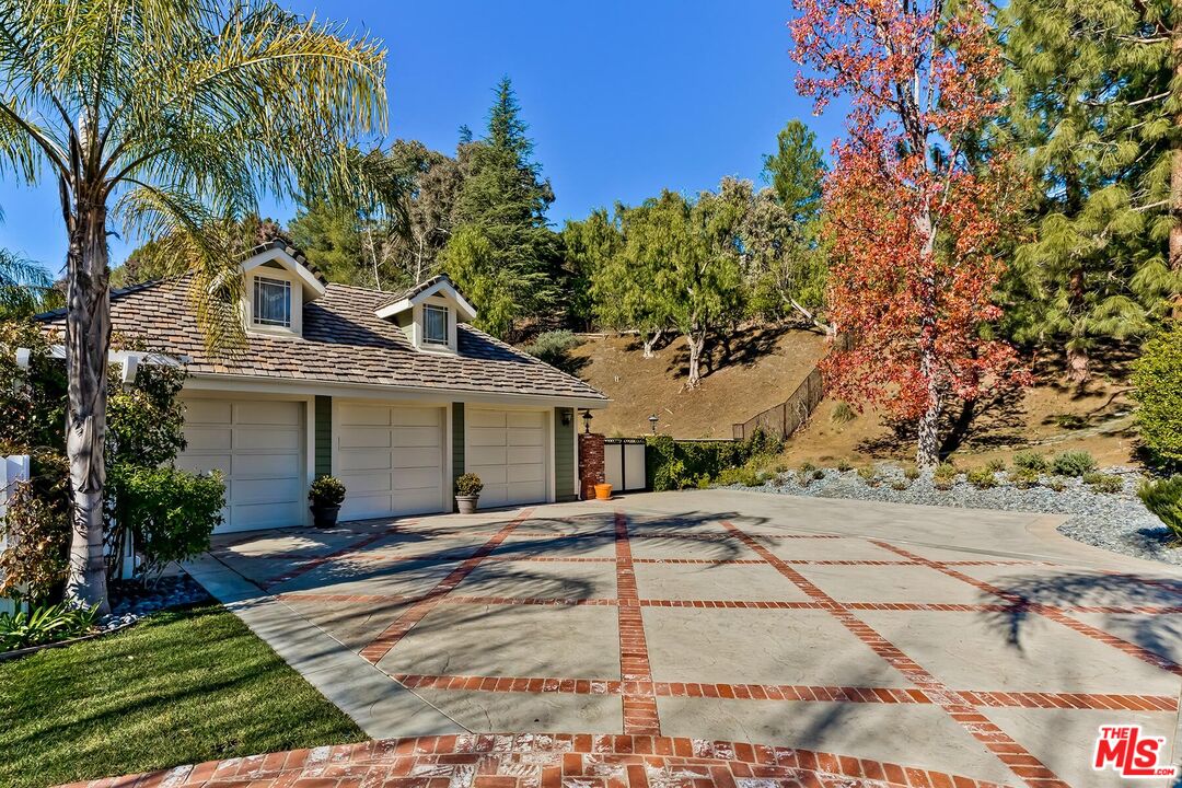 3827 Castle View Road Agoura Hills, CA 91301 - Photo 5 of 74 a front view of a house with a yard