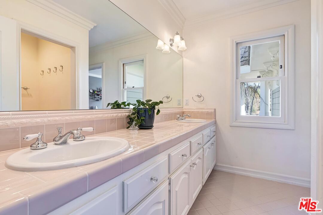 3827 Castle View Road Agoura Hills, CA 91301 - Photo 51 of 74 a bathroom with a double vanity sink and a mirror