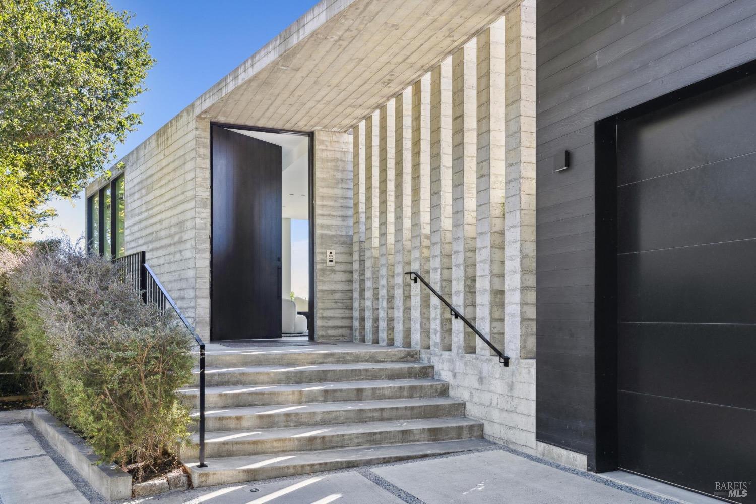 a view of entryway with wooden floor and stairs