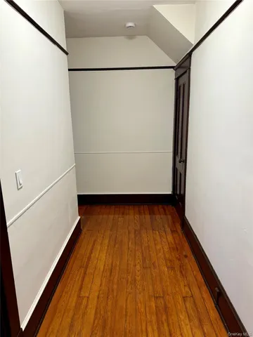 a view of closet with wooden floor