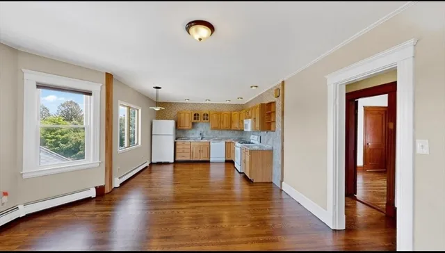 a view of a living room with hardwood floor and a window