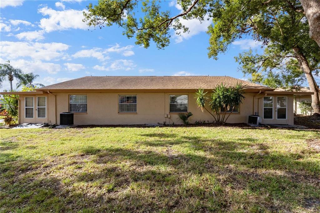 409 Feltham Trail, Unit B Sun City Center, FL 33573 - Photo 20 of 34 a front view of a house with a garden