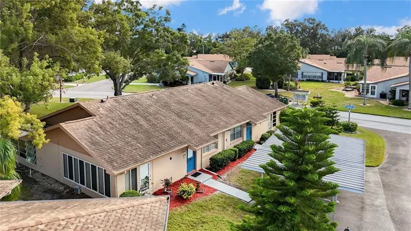 an aerial view of a house with a yard table and chairs