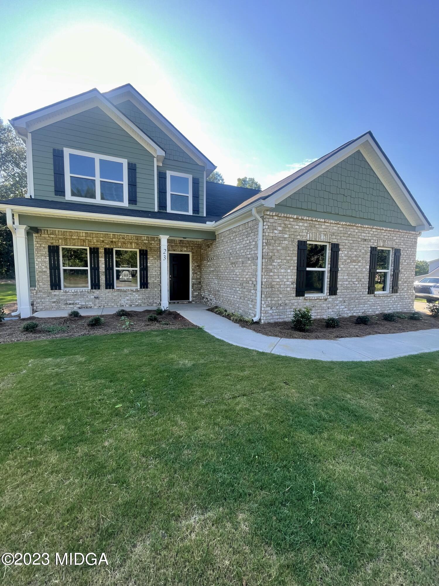 23 Strickland Loop Forsyth, GA 31029 - Photo 1 of 9 a front view of a house with yard and green space