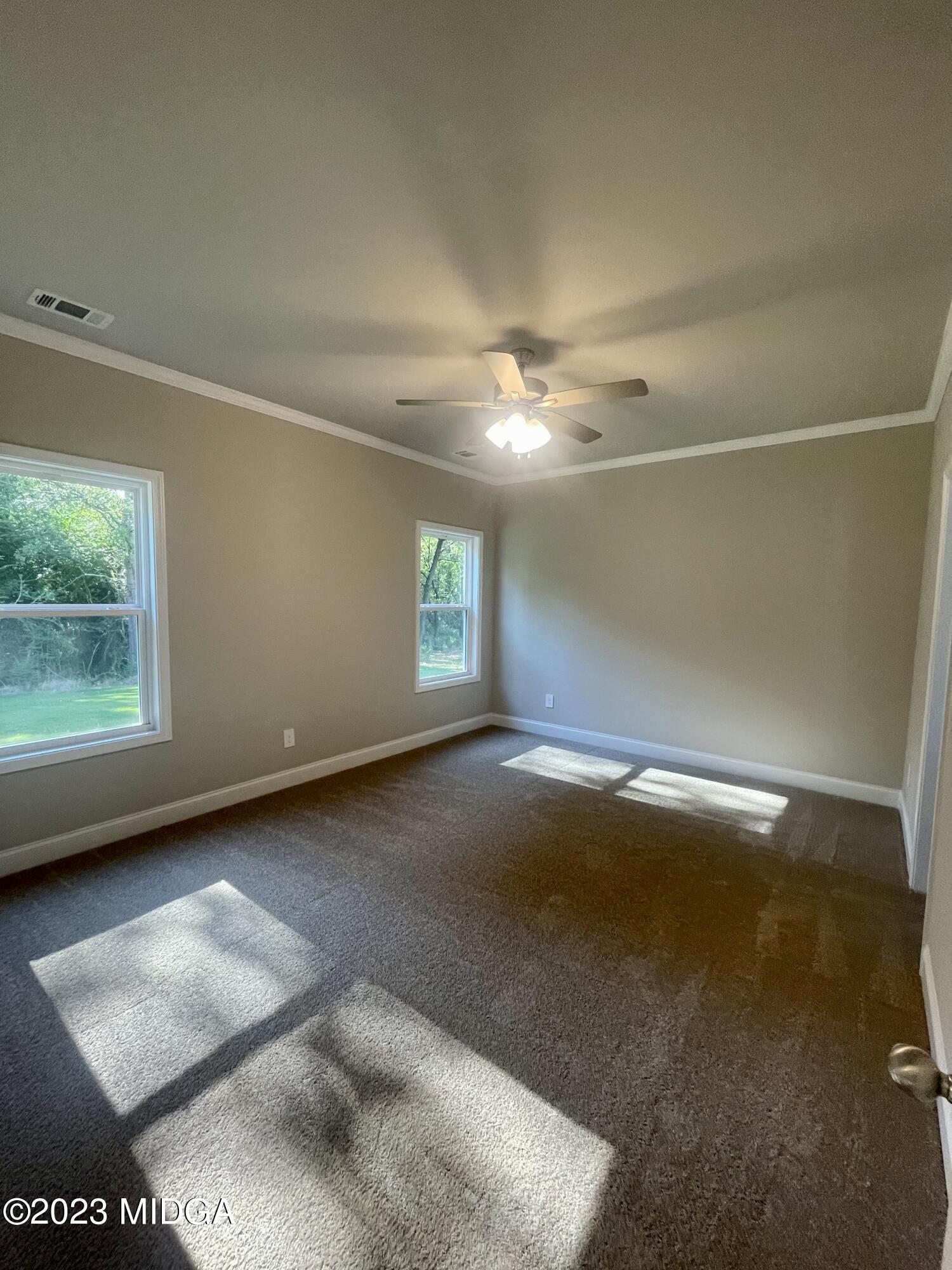 23 Strickland Loop Forsyth, GA 31029 - Photo 5 of 9 a view of a livingroom with furniture and chandelier fan