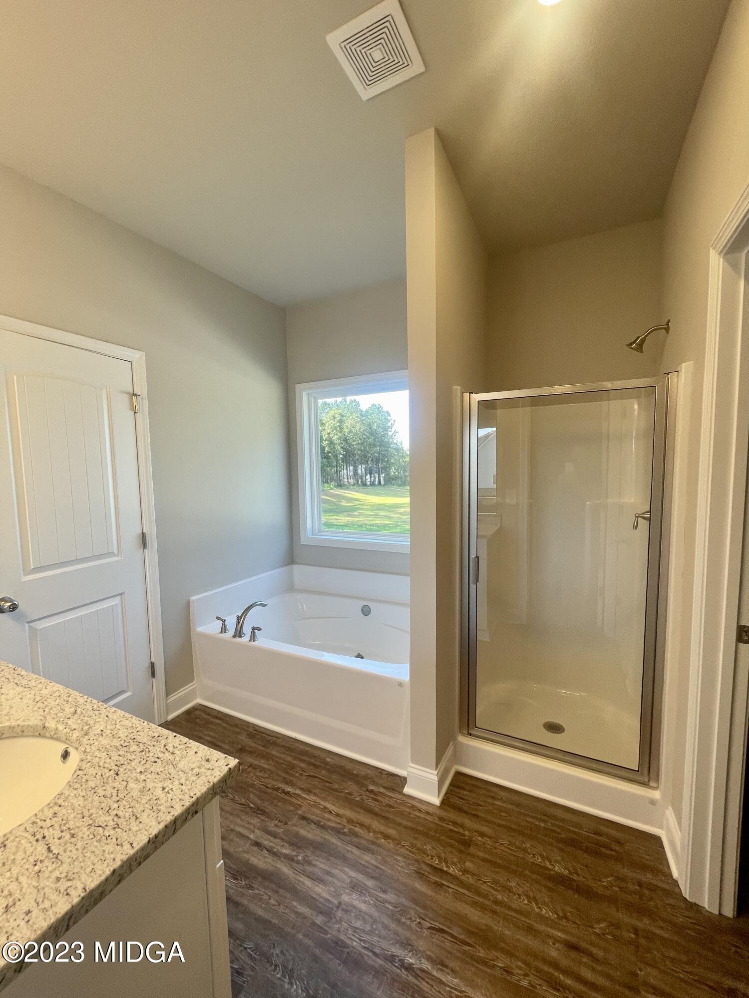23 Strickland Loop Forsyth, GA 31029 - Photo 7 of 9 a bathroom with a tub and shower