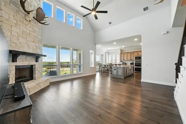a view of a living room a fireplace and windows in a room