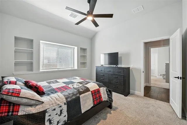 a bedroom with a bed and a tv