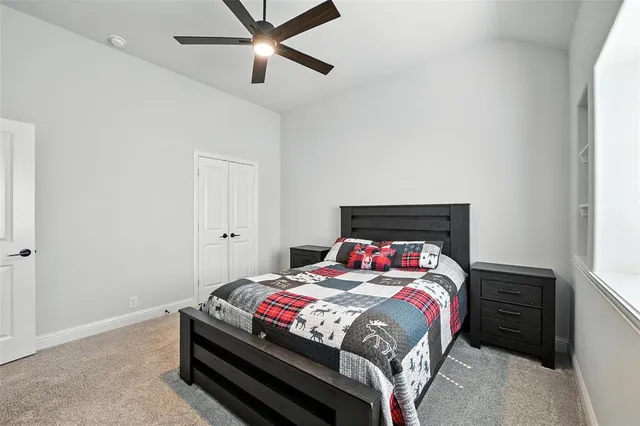 a bedroom with a bed and a ceiling fan