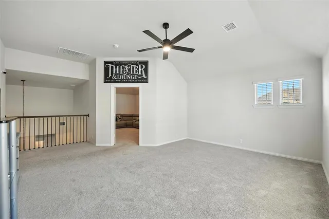 a view of a hallway with a ceiling fan