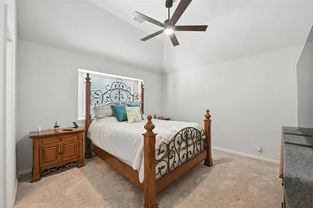 a bed sitting in a bedroom next to a window