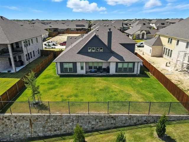 an aerial view of a house with a swimming pool