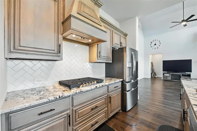 a kitchen with stainless steel appliances granite countertop a stove and a refrigerator