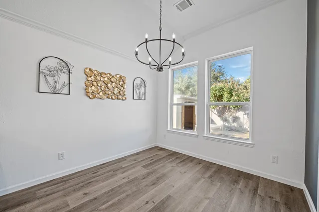 a view of a room with wooden floor and window