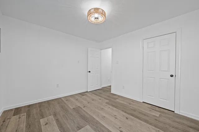 a view of room with wooden floor