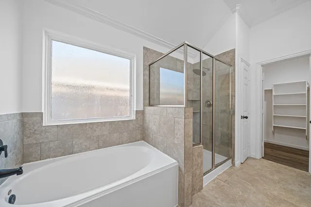 a bathroom with a bathtub and a shower