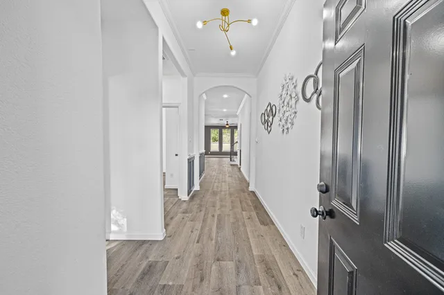 a view of a hallway with wooden floor