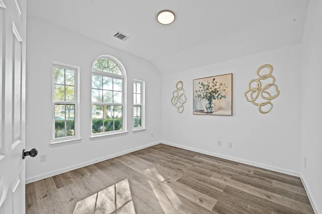 an empty room with windows and closet