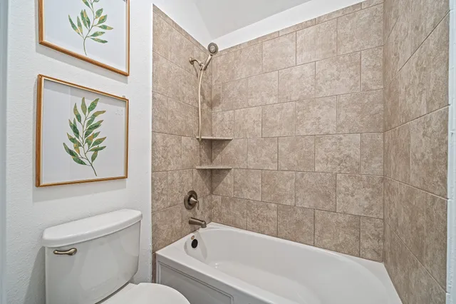 a bathroom with a bathtub and a toilet